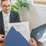 Doradca kredytowy omawia z klientem dokumenty dotyczące rat kredytu