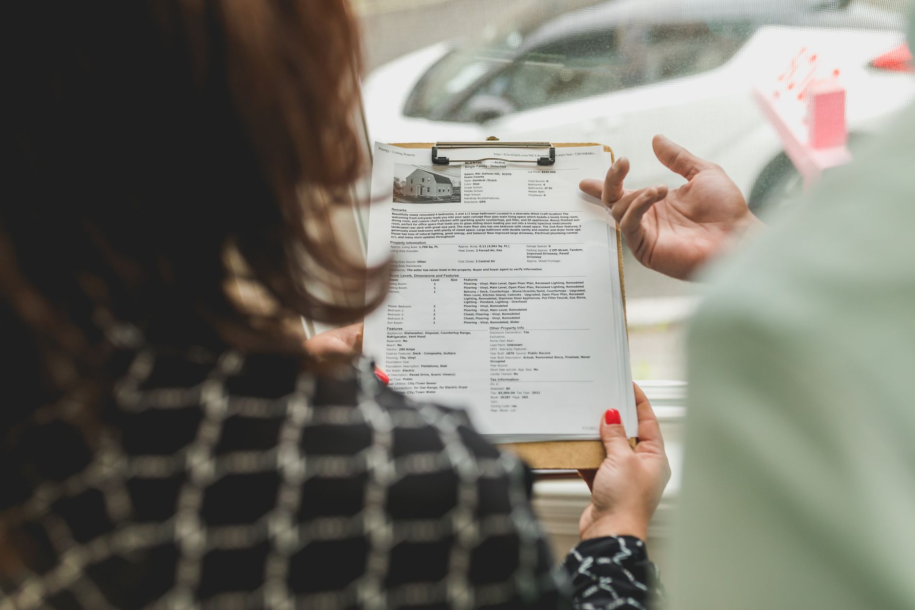Agent nieruchomości omawia z klientem dokumenty dotyczące mieszkania